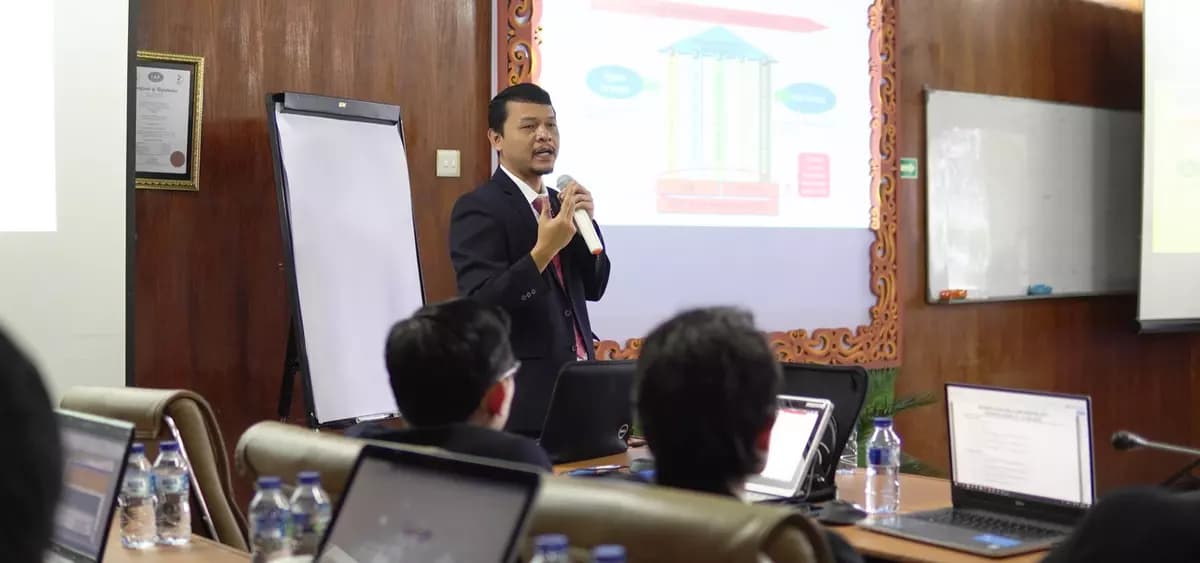 Director of PT. Berkah Bersaudara presenting to the team in a training room