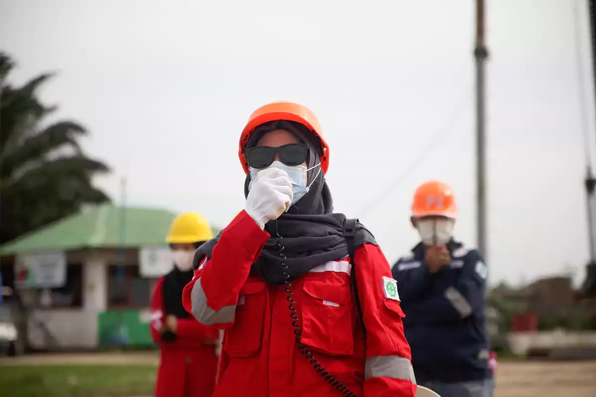 PT. Berkah Bersaudara field officer in safety uniform, helmet, and mask